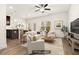 Staged living room with modern furnishings, wood floors, and natural light at 11112 Benton Woods Dr, Covington, GA 30014