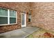 This patio has a door to the house and a single light fixture at 11112 Benton Woods Dr, Covington, GA 30014