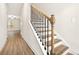 Elegant staircase featuring wood steps, white risers, and black iron railing at 11112 Benton Woods Dr, Covington, GA 30014