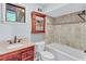 Bathroom with a single sink vanity, a wall to wall mirror, a toilet and a bathtub with tiled wall at 1668 Terrell Ridge Se Dr, Marietta, GA 30067