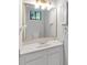 Bright bathroom featuring a granite countertop and updated vanity and gold accented mirror at 1668 Terrell Ridge Se Dr, Marietta, GA 30067