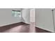 Bedroom featuring hardwood floors, a window, and a doorway leading to the staircase landing at 1668 Terrell Ridge Se Dr, Marietta, GA 30067