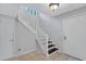 Bright entryway featuring a white staircase, tile flooring, and contemporary lighting fixtures at 1668 Terrell Ridge Se Dr, Marietta, GA 30067