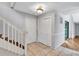 Entryway featuring tile flooring, stairs with white railings, and a closet with white folding doors at 1668 Terrell Ridge Se Dr, Marietta, GA 30067