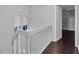 Hallway with dark hardwood floors, white stairs and railings, and a door leading to another room at 1668 Terrell Ridge Se Dr, Marietta, GA 30067