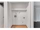 Laundry room with washer and dryer hookups with laminate floor, bi-fold doors, and a shelf at 1668 Terrell Ridge Se Dr, Marietta, GA 30067