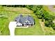An aerial view shows this beautifully landscaped new construction home on an expansive lot with mature trees at 300 Eminence Peak, Rydal, GA 30171
