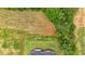 Stunning aerial view showcasing a beautiful lawn, farmland, and luscious trees surrounding the home at 300 Eminence Peak, Rydal, GA 30171
