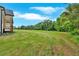 Backyard featuring a sprawling lawn and partial view of the home's rear exterior at 300 Eminence Peak, Rydal, GA 30171