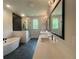 Modern bathroom boasts a freestanding tub, glass-enclosed shower, and dual vanities at 300 Eminence Peak, Rydal, GA 30171