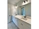 Well-lit bathroom featuring a double sink vanity and large mirror, adding space and functionality at 300 Eminence Peak, Rydal, GA 30171
