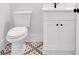 Well-lit bathroom featuring decorative tile flooring, white vanity, and contemporary fixtures at 300 Eminence Peak, Rydal, GA 30171