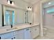 Stylish bathroom showcasing double vanity, granite countertops and a bright shower with a tiled accent wall at 300 Eminence Peak, Rydal, GA 30171