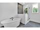 Elegant bathroom featuring a soaking tub and glass-enclosed shower with tile surround at 300 Eminence Peak, Rydal, GA 30171