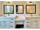 Bathroom featuring double sinks with stylish fixtures, mirrors and cabinet space at 300 Eminence Peak, Rydal, GA 30171