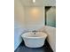Modern bathtub with matte black fixtures is situated next to a seamless glass shower at 300 Eminence Peak, Rydal, GA 30171