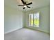 Inviting bedroom featuring a modern ceiling fan and a large window overlooking the green lawn at 300 Eminence Peak, Rydal, GA 30171