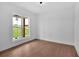 Modern bedroom with wood floors, white walls, and a large window overlooking the lawn at 300 Eminence Peak, Rydal, GA 30171