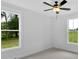 Bedroom with neutral carpet, two windows offering natural light, and a ceiling fan at 300 Eminence Peak, Rydal, GA 30171
