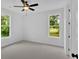 Spacious bedroom with two large windows, neutral carpet, ceiling fan, and recessed lighting at 300 Eminence Peak, Rydal, GA 30171