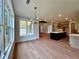 Spacious dining area with modern chandelier, hardwood floors, and view of kitchen at 300 Eminence Peak, Rydal, GA 30171
