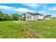 View of the side of a white home with a well-manicured lawn on a clear day at 300 Eminence Peak, Rydal, GA 30171
