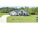 Beautiful white farmhouse-style home with a dark roof, covered front porch, and black window frames at 300 Eminence Peak, Rydal, GA 30171