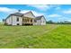Backyard featuring a sprawling lawn and view of the home's rear exterior at 300 Eminence Peak, Rydal, GA 30171