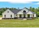Charming modern farmhouse with large front yard, wooden columns, and black trim windows at 300 Eminence Peak, Rydal, GA 30171