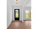 Foyer has wood floor, white trim, and a front door that provides a view to the lawn at 300 Eminence Peak, Rydal, GA 30171