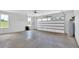Spacious two car garage features a concrete floor, white walls, and large windows at 300 Eminence Peak, Rydal, GA 30171