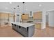 Contemporary kitchen featuring center island with cooktop, stainless appliances, and ample storage at 300 Eminence Peak, Rydal, GA 30171