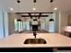 Open-concept kitchen featuring stainless steel sink, and view of great room with fireplace at 300 Eminence Peak, Rydal, GA 30171
