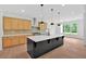 Modern kitchen with a black island, pendant lights, and stainless steel appliances at 300 Eminence Peak, Rydal, GA 30171