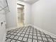 Laundry Room with decorative tile flooring and open door to closet space at 300 Eminence Peak, Rydal, GA 30171