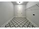 Laundry Room with decorative tile flooring, white walls, and metal shelving at 300 Eminence Peak, Rydal, GA 30171