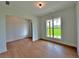 Open living room with a large window, hardwood floors and natural light showcasing the home's welcoming ambiance at 300 Eminence Peak, Rydal, GA 30171