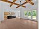 Open-concept living space with hardwood floors, fireplace, and kitchen with island at 300 Eminence Peak, Rydal, GA 30171