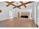 Open-concept living room flows into kitchen, showcasing hardwood floors and exposed beams at 300 Eminence Peak, Rydal, GA 30171