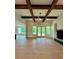Spacious living room with wood beams, a fireplace, and natural light from the windows at 300 Eminence Peak, Rydal, GA 30171