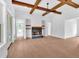 Open living room with hardwood floors, stone fireplace, and beamed ceilings at 300 Eminence Peak, Rydal, GA 30171