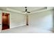 Large main bedroom showcases a tray ceiling, fan, and access to the walk-in closet at 300 Eminence Peak, Rydal, GA 30171