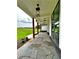 Covered patio featuring stone flooring and wood supports with manicured lawn in view at 300 Eminence Peak, Rydal, GA 30171
