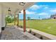 Covered porch with stone floor and thick wooden posts framing a well manicured lawn at 300 Eminence Peak, Rydal, GA 30171