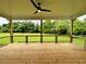 Covered porch featuring green field view, wood railings, and wood flooring at 300 Eminence Peak, Rydal, GA 30171