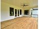 Covered porch featuring exterior windows, wood flooring, and ceiling fan at 300 Eminence Peak, Rydal, GA 30171