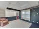 Finished basement featuring built-in shelves and carpeted floor, adjacent room visible at 4092 Deerbrook Sw Way, Lilburn, GA 30047