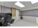 Finished basement with versatile space, including a desk area and neutral carpeting at 4092 Deerbrook Sw Way, Lilburn, GA 30047