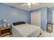 Blue bedroom featuring carpet, double closets, and decorative elements at 4092 Deerbrook Sw Way, Lilburn, GA 30047