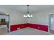 Classic dining room with white and red walls, chandelier, and neutral carpet at 4092 Deerbrook Sw Way, Lilburn, GA 30047